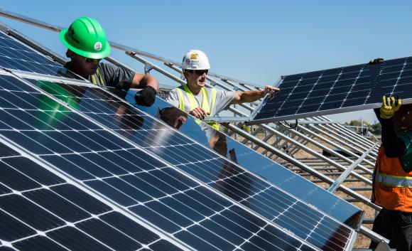 group of men installing solar panels